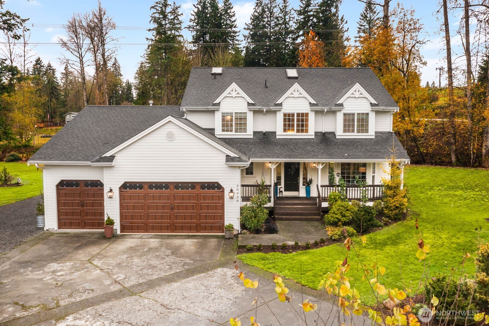 20928 Welch Road Snohomish, WA 98296 - Photo 1 of 29 a front view of a house with a yard and garage