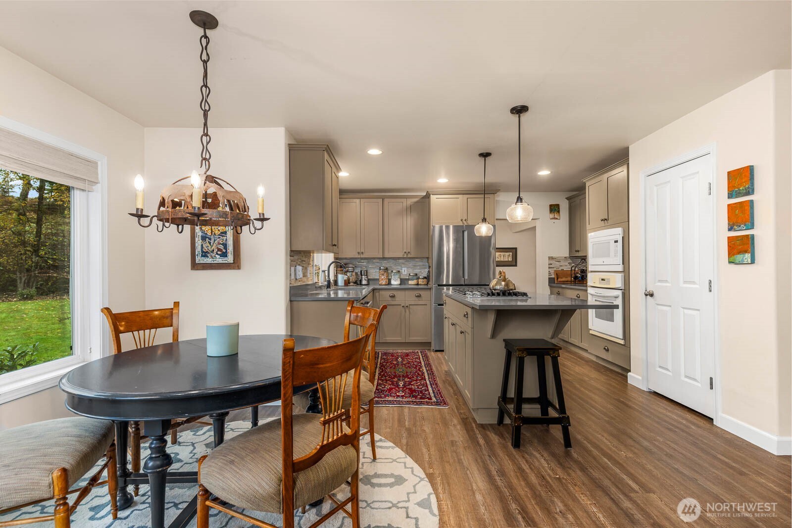 20928 Welch Road Snohomish, WA 98296 - Photo 11 of 29 a dining room filled a chandelier a potted plant and a dining table with chairs