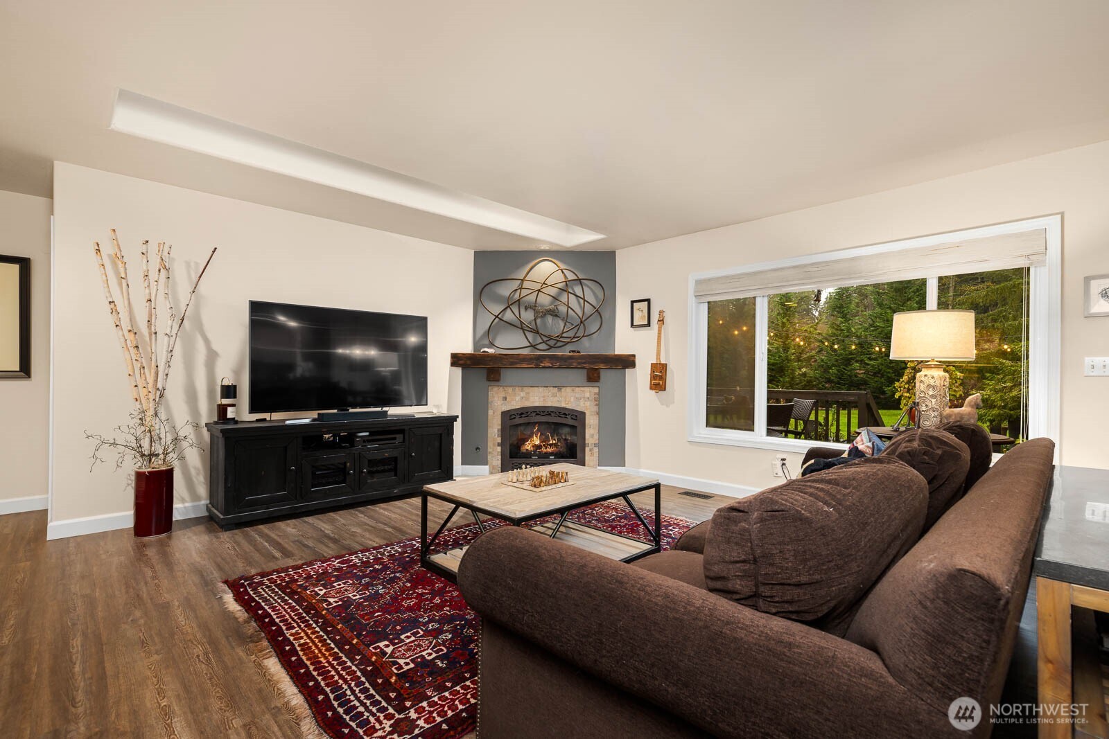 20928 Welch Road Snohomish, WA 98296 - Photo 13 of 29 a living room with furniture a flat screen tv and a fireplace