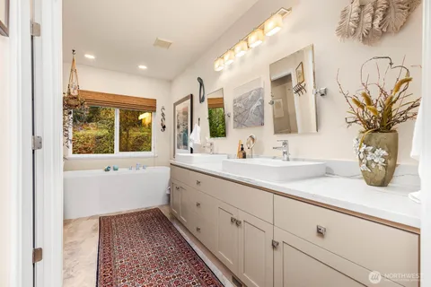 a bathroom with a sink a mirror and a window