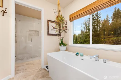 a bathroom with a bathtub and shower