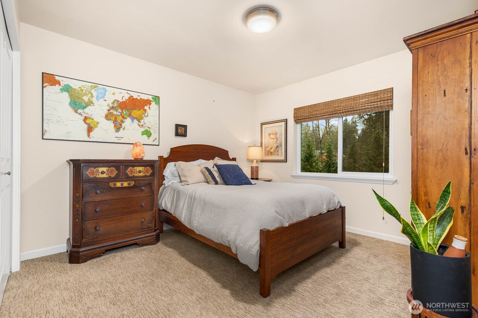 20928 Welch Road Snohomish, WA 98296 - Photo 22 of 29 a spacious bedroom with a bed painting on wall and a potted plant
