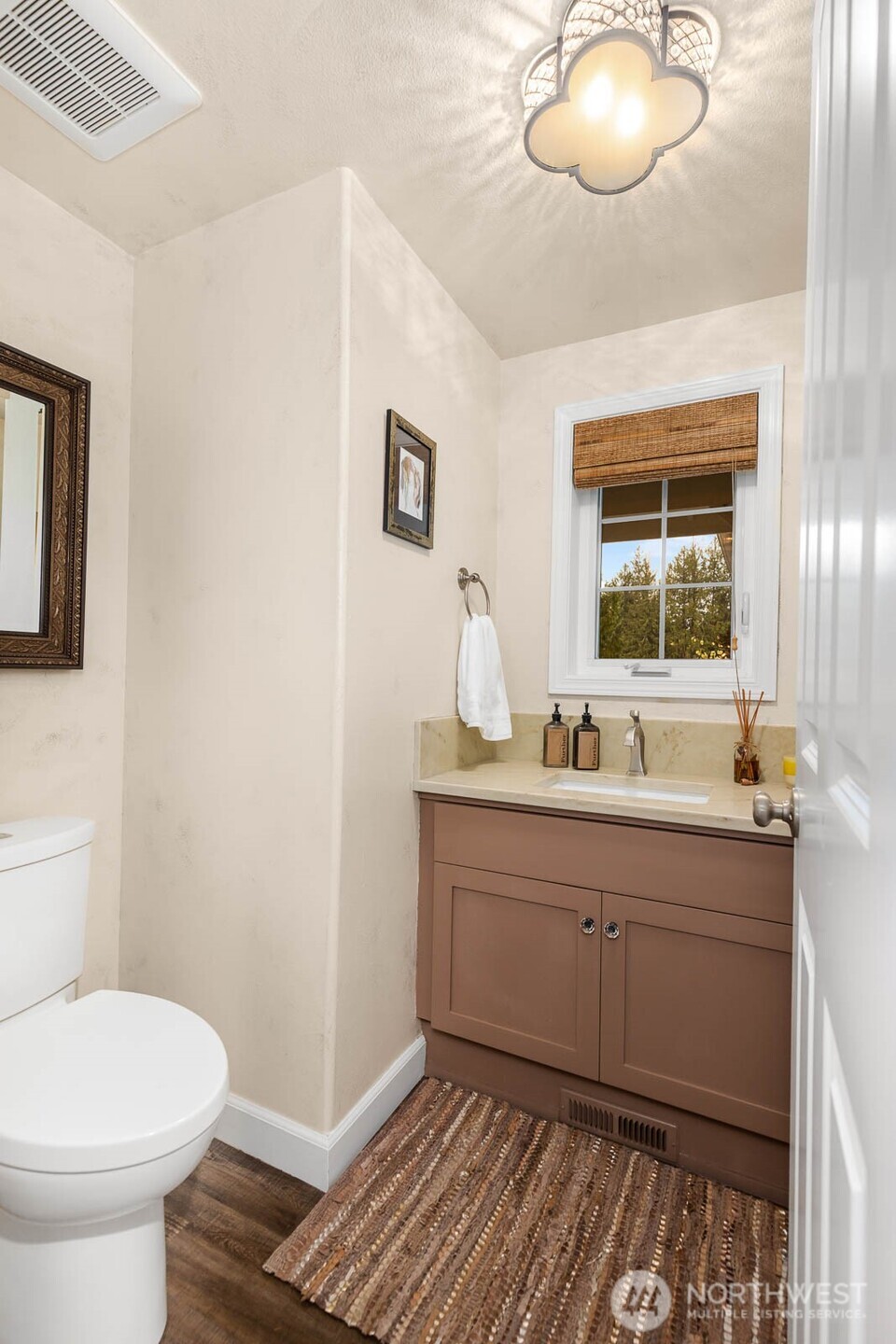 20928 Welch Road Snohomish, WA 98296 - Photo 23 of 29 a bathroom with a toilet a sink and mirror