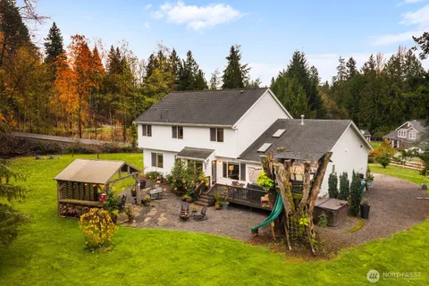 a view of a house with backyard porch and sitting area