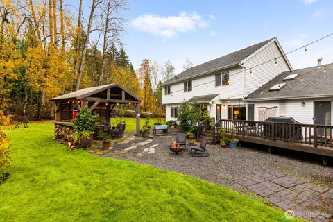 a view of a house with backyard porch and sitting area