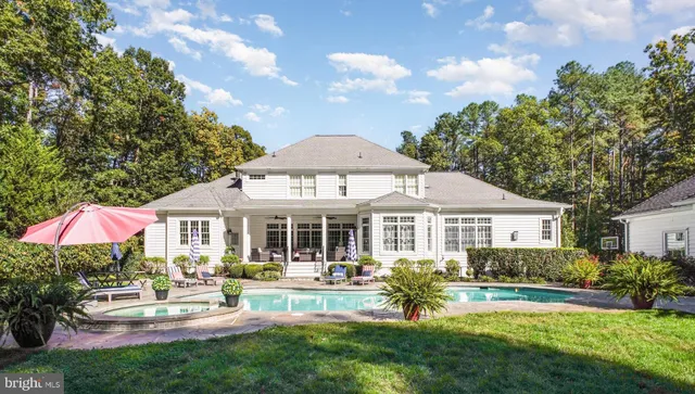 a front view of a house with garden and sitting area