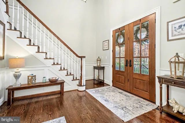 a dining room with furniture a chandelier and wooden floor