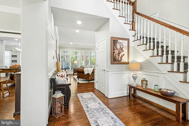 a view of a dining room with furniture a chandelier and wooden floor