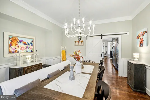 a kitchen with stainless steel appliances kitchen island granite countertop a sink a stove a dining table and chairs