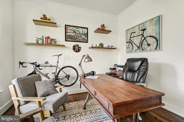 a view of a workspace with furniture and a window