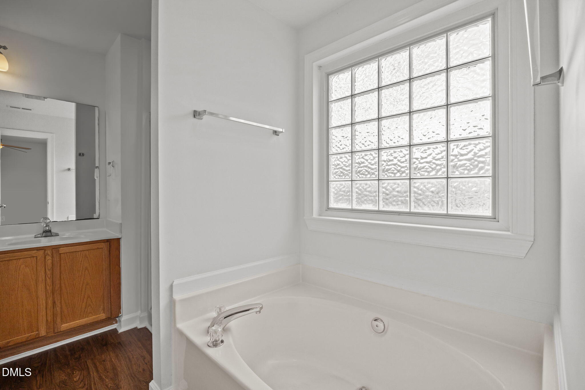 9220 Pennythorne Court Raleigh, NC 27615 - Photo 29 of 49 a bathroom with a tub a sink and a window
