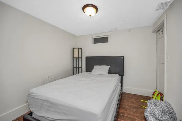 a bedroom with a bed and a view of en suite bathroom