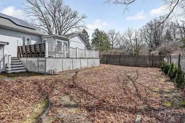a view of a backyard with couches chair and wooden floor