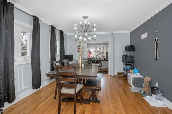 a view of a dining room with furniture and wooden floor
