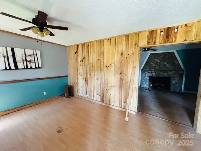 a view of an empty room with window and cabinet