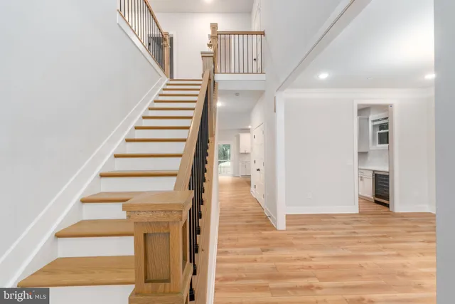 a view of an empty room wooden floor and a window