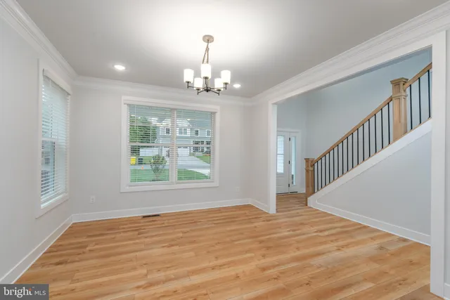 wooden floor in an empty room with a window and wooden floor