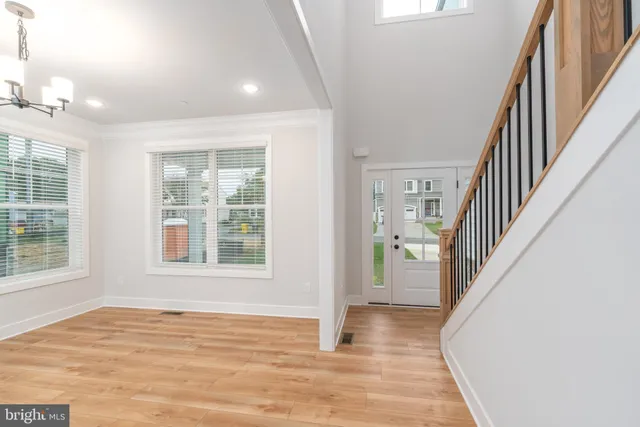 a view of a livingroom with furniture wooden floor and windows