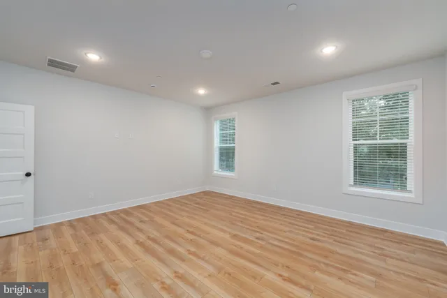 a bathroom with a granite countertop sink a toilet and a mirror