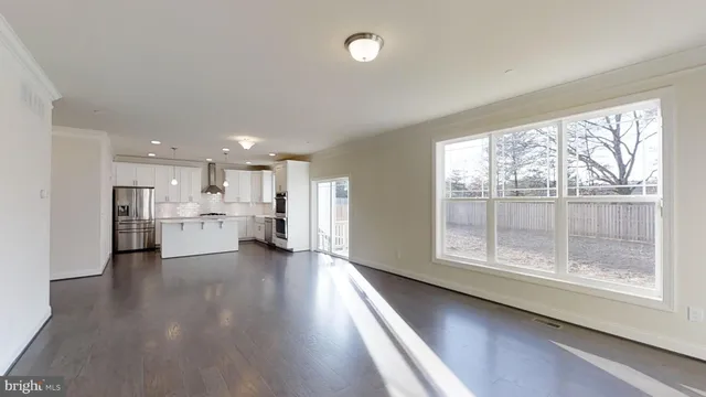 a kitchen with stainless steel appliances granite countertop a refrigerator a sink and a stove