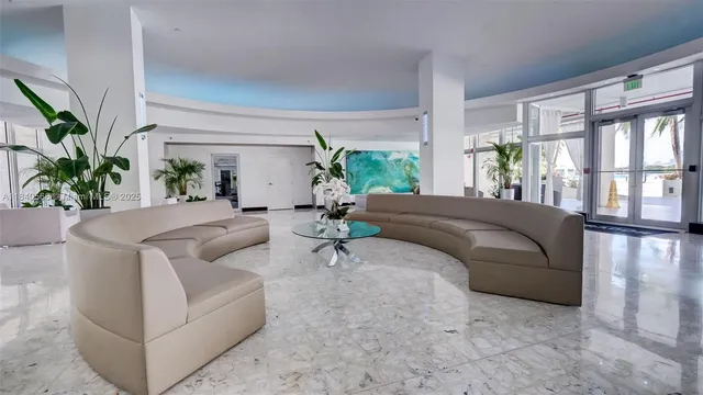 a living room with furniture and large windows