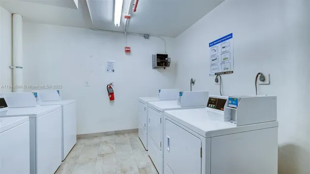 a view of storage and utility room with two washing machine