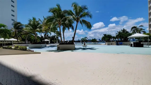 a palm tree sitting in front of a building with palm trees