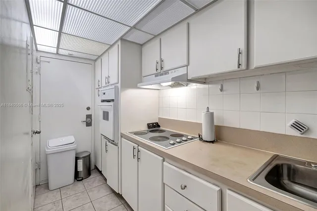 a kitchen with a sink and cabinets