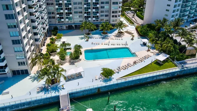 an aerial view of a house with a garden and swimming pool