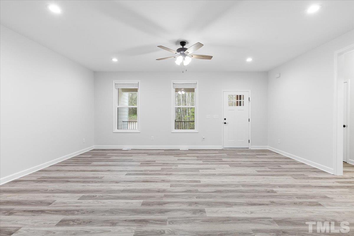 1893 Pilot-Riley Road Zebulon, NC 27597 - Photo 11 of 50 a view of empty room with window and ceiling fan