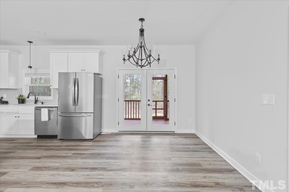 1893 Pilot-Riley Road Zebulon, NC 27597 - Photo 15 of 50 a kitchen with stainless steel appliances granite countertop a refrigerator and a stove top oven