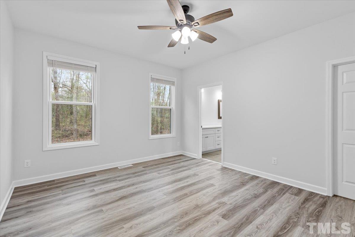 1893 Pilot-Riley Road Zebulon, NC 27597 - Photo 20 of 50 a view of an empty room with a window and a kitchen