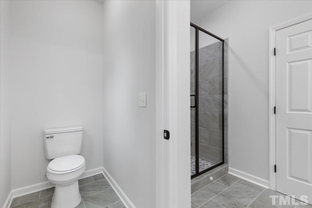 1893 Pilot-Riley Road Zebulon, NC 27597 - Photo 25 of 50 a bathroom with a toilet and a shower