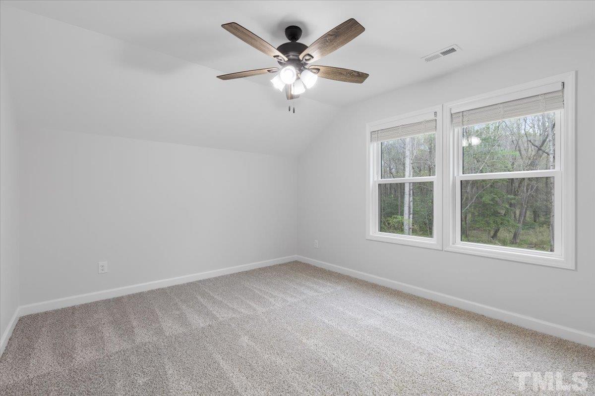 1893 Pilot-Riley Road Zebulon, NC 27597 - Photo 42 of 50 an empty room with windows and fan