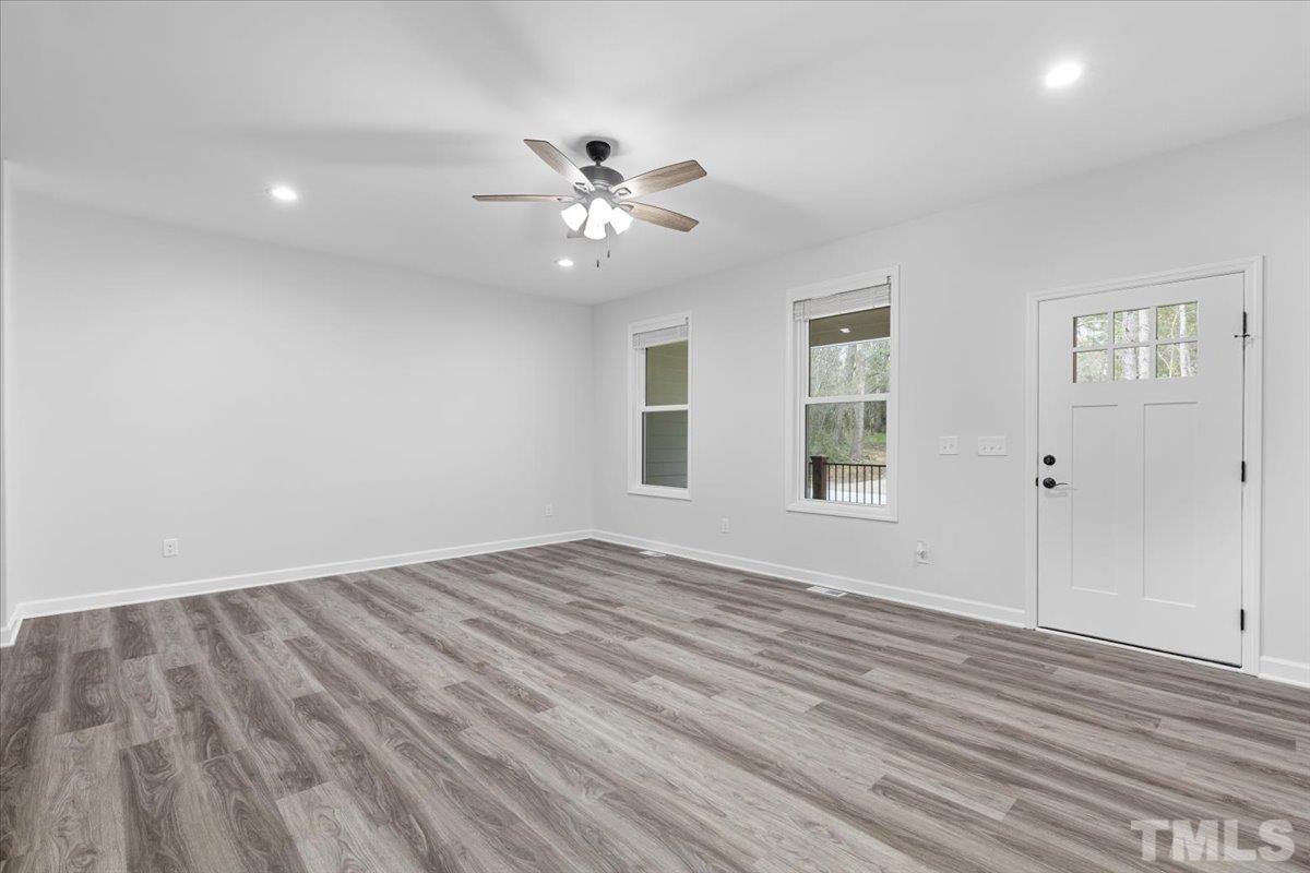 1893 Pilot-Riley Road Zebulon, NC 27597 - Photo 10 of 50 a view of empty room with wooden floor and fan