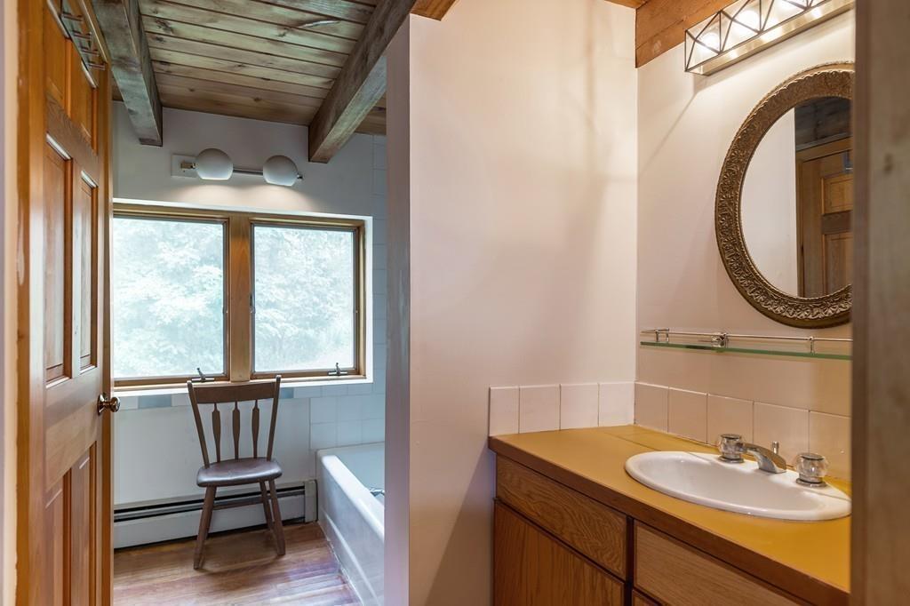 190 Argilla Road Ipswich, MA 01938 - Photo 16 of 40 a bathroom with a sink a mirror and a window