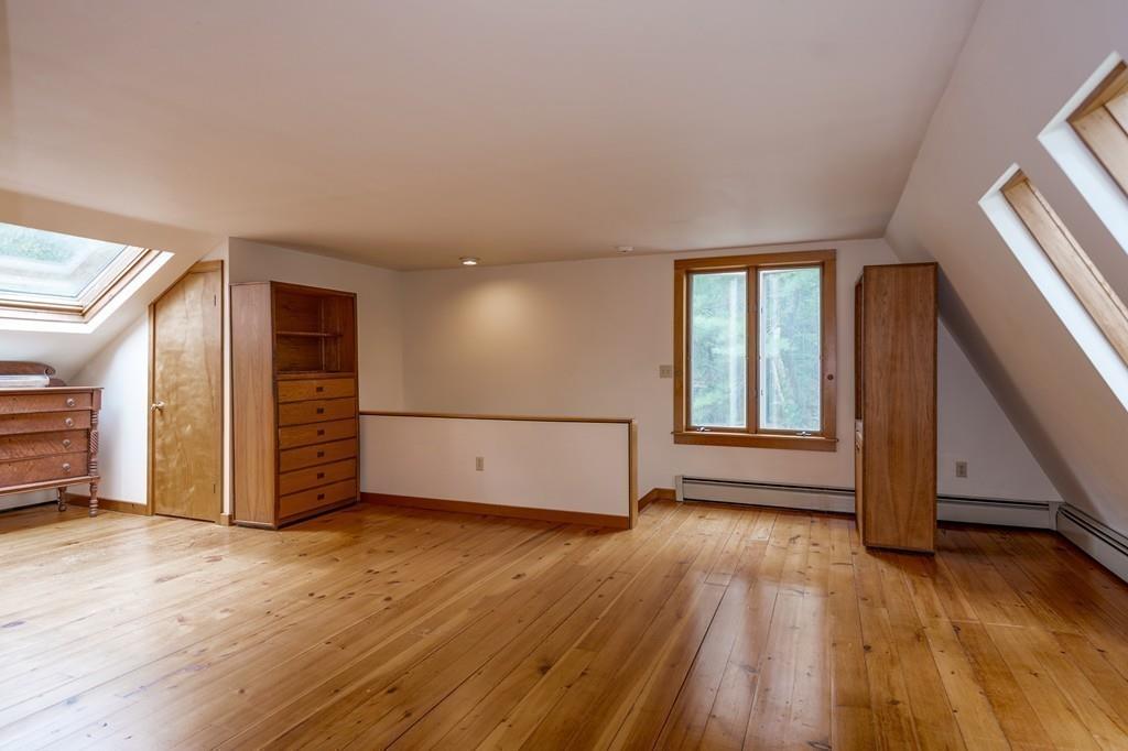 190 Argilla Road Ipswich, MA 01938 - Photo 18 of 40 an empty room with wooden floor and windows