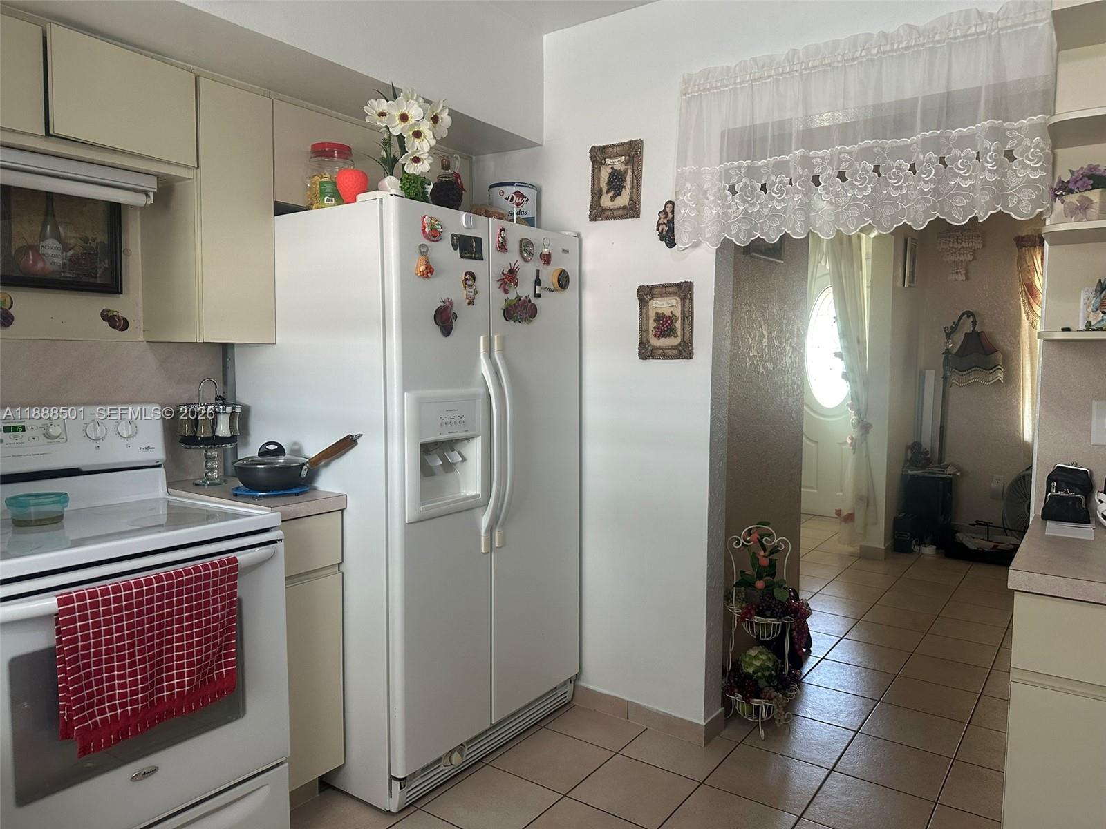 265 West 55th Street Hialeah, FL 33012 - Photo 16 of 58 a kitchen with stainless steel appliances a refrigerator and a stove