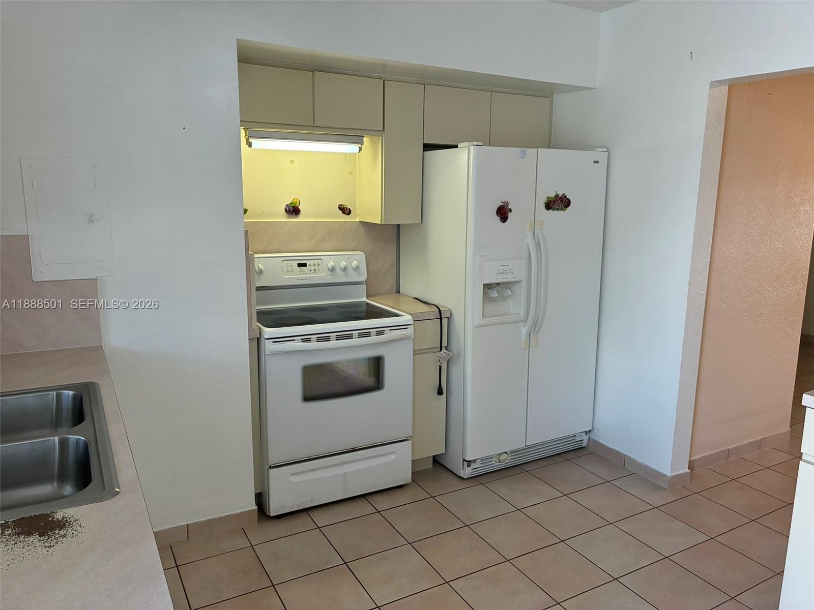 265 West 55th Street Hialeah, FL 33012 - Photo 17 of 58 a kitchen with white cabinets and white appliances