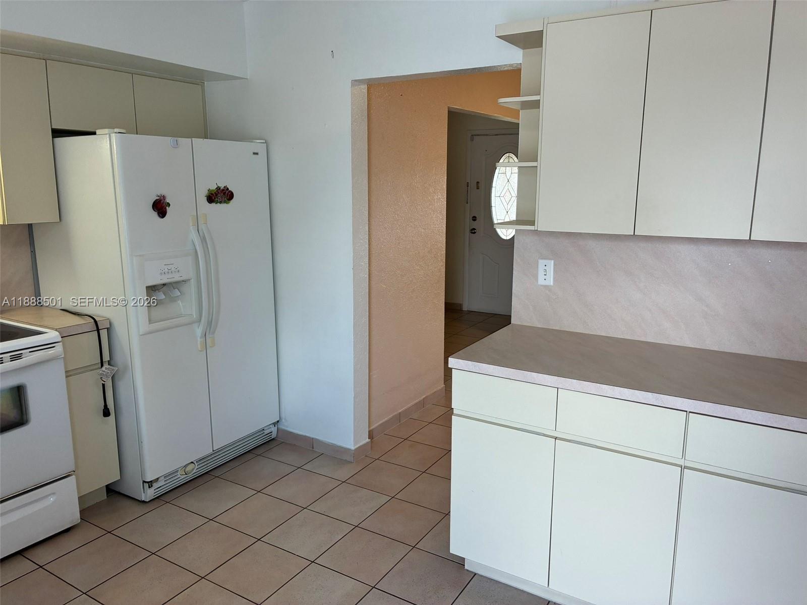 265 West 55th Street Hialeah, FL 33012 - Photo 19 of 58 a kitchen with a refrigerator and cabinets