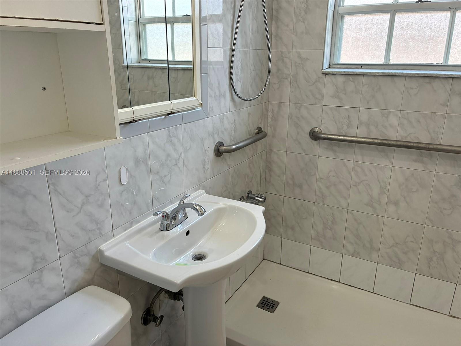 265 West 55th Street Hialeah, FL 33012 - Photo 26 of 58 a bathroom with a sink a toilet and a shower