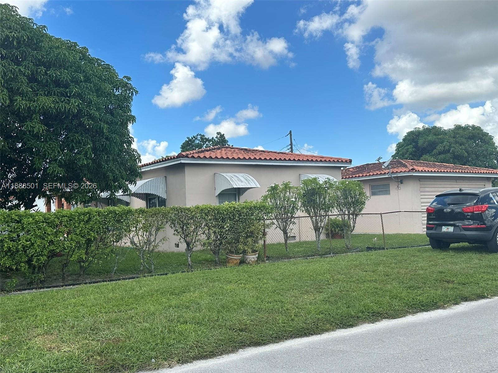 265 West 55th Street Hialeah, FL 33012 - Photo 3 of 58 a view of a house with a yard and a garden