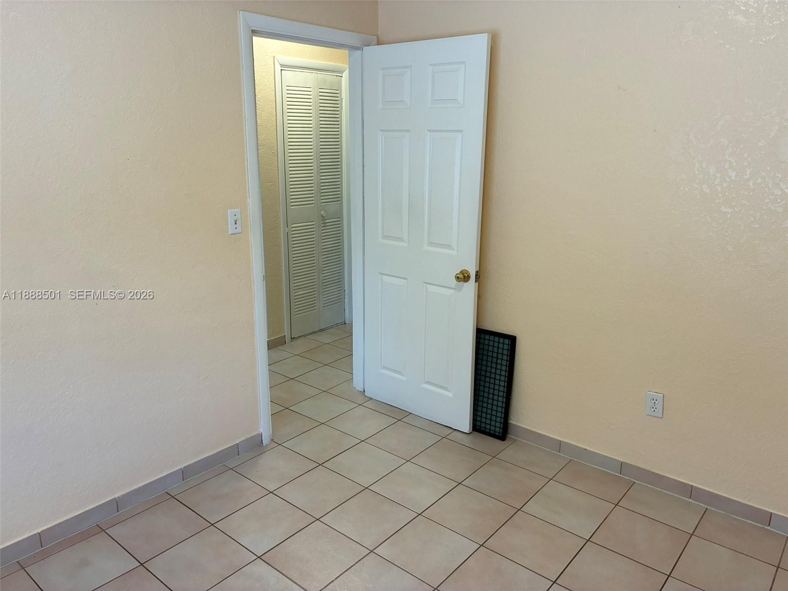 265 West 55th Street Hialeah, FL 33012 - Photo 45 of 58 an empty room with wooden door