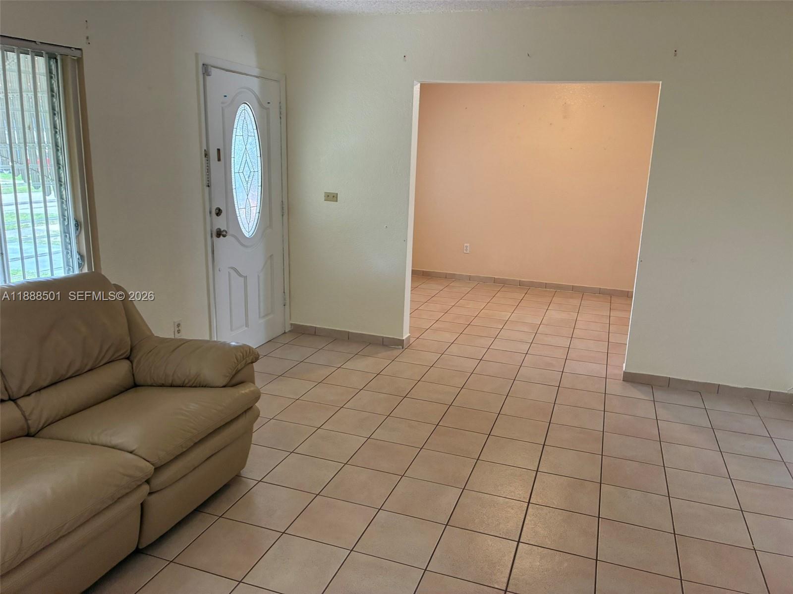 265 West 55th Street Hialeah, FL 33012 - Photo 47 of 58 a living room with furniture and a rug