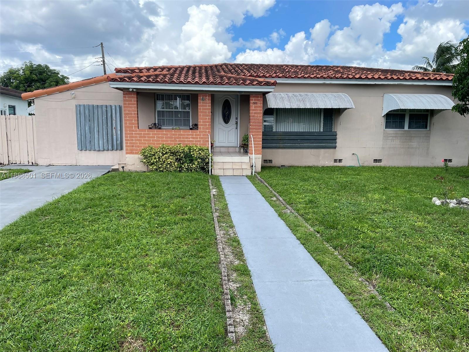265 West 55th Street Hialeah, FL 33012 - Photo 5 of 58 a front view of a house with garden