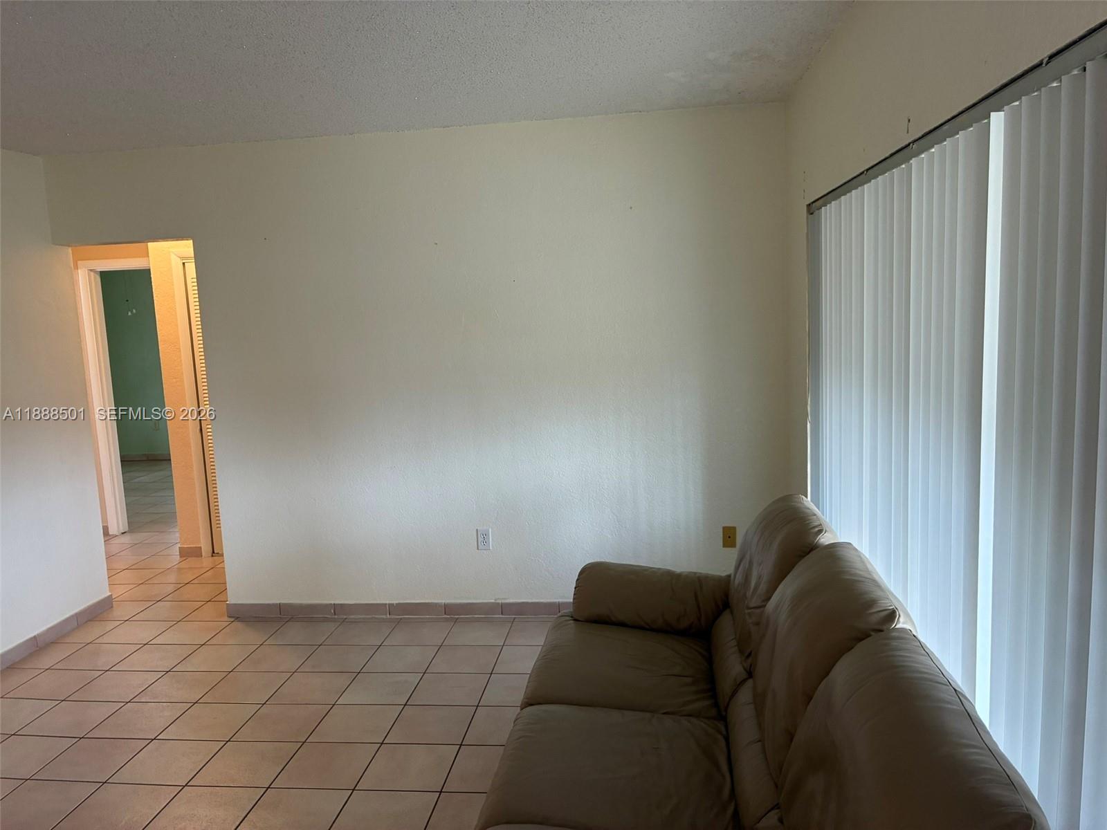 265 West 55th Street Hialeah, FL 33012 - Photo 52 of 58 a living room with furniture and a gate