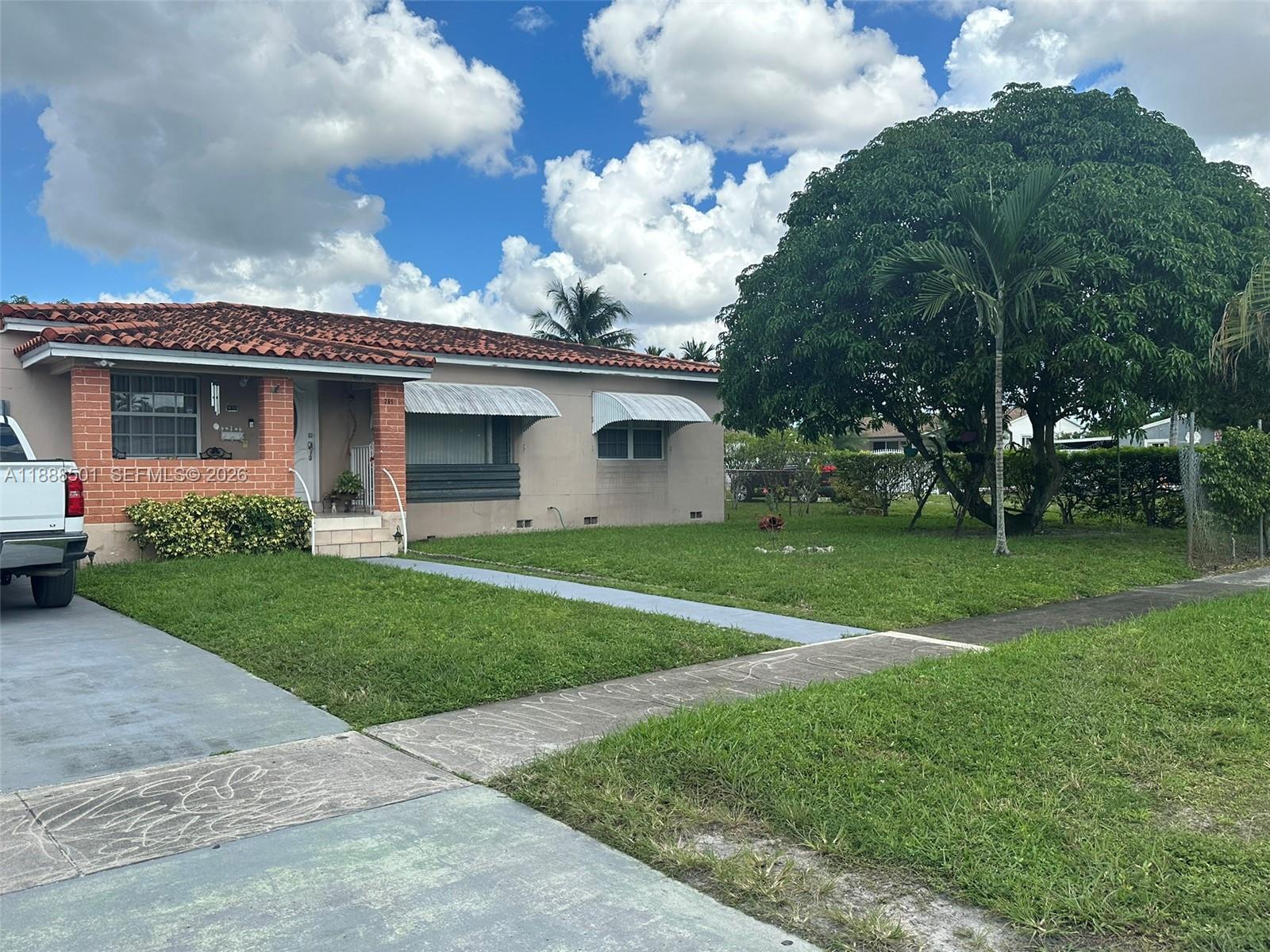 265 West 55th Street Hialeah, FL 33012 - Photo 8 of 58 a front view of house with a garden