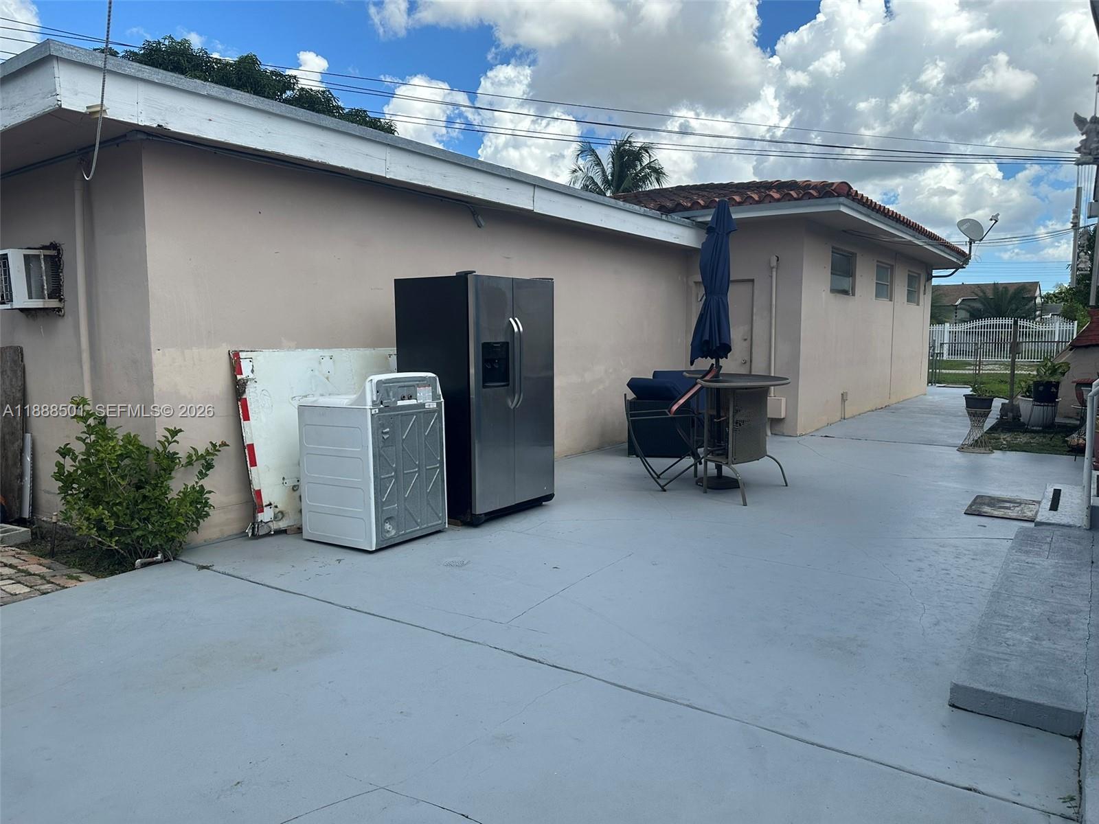 265 West 55th Street Hialeah, FL 33012 - Photo 9 of 58 a view of a chair and tables in patio of the house