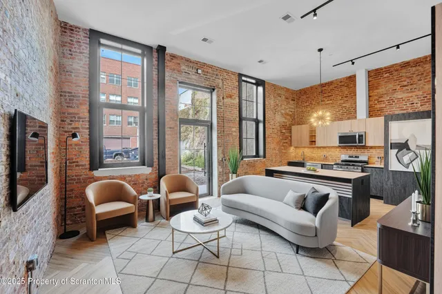 a living room with fireplace furniture and a window