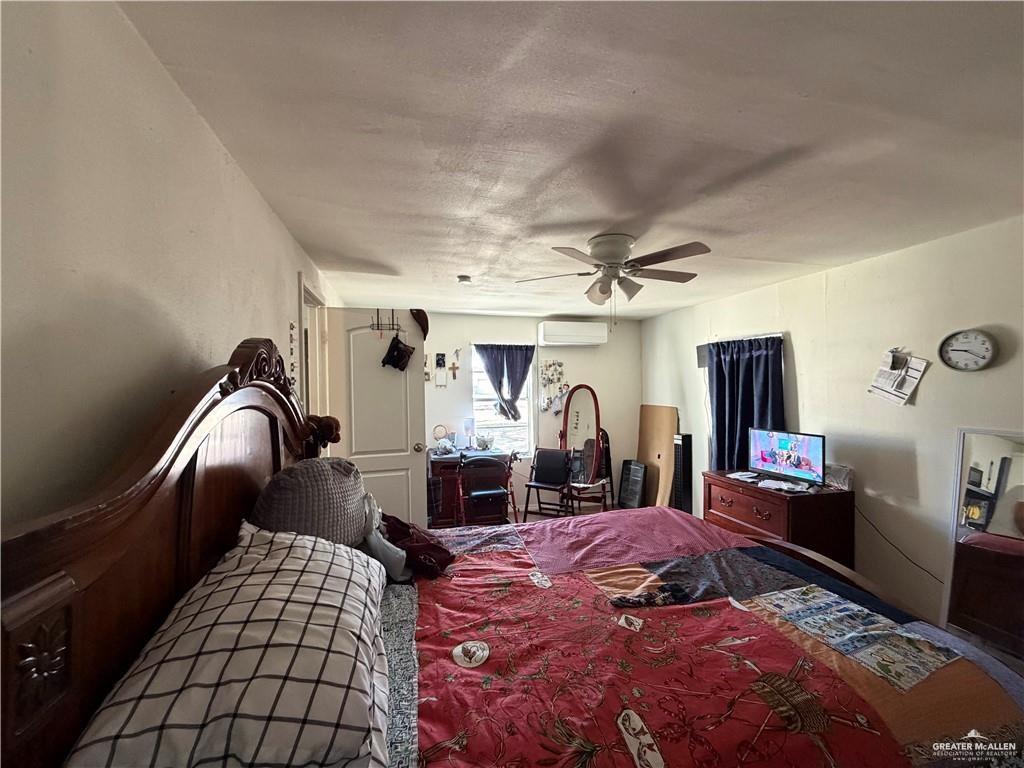 865 Rio Grande Street San Benito, TX 78586 - Photo 2 of 10 a bedroom with bed and window
